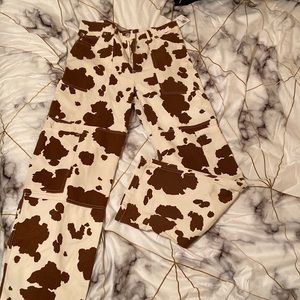 Brown cow print cargo pants. Size: Large